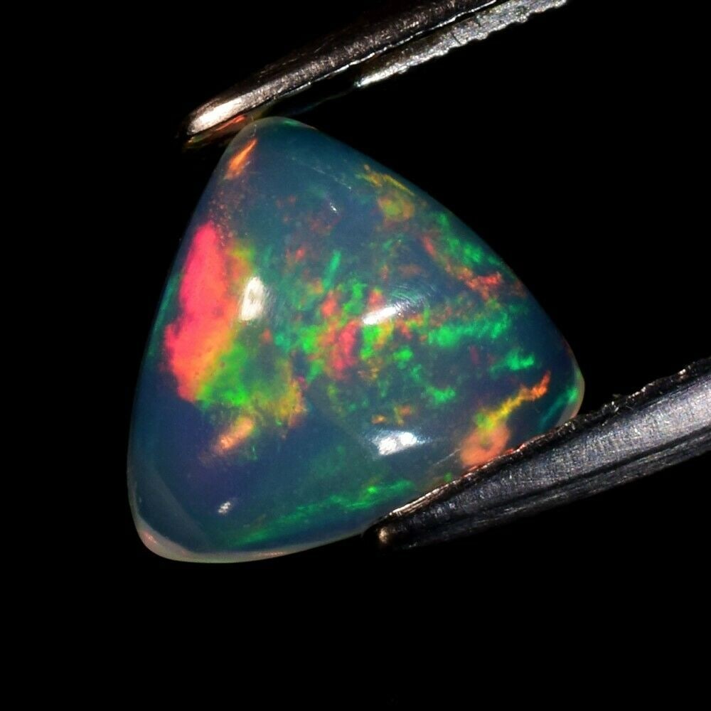 1.43 ct. Play of Color Natural White Opal - ETHIOPIA: 1.43 ct. Play of Color Natural White Opal - ETHIOPIA Cut - Triangle Cabochon Color - Floral Flash Rainbow (White, Red, Orange, Green, Yellow, Violet, Blue Flashing) Ct. Weight - 1.43 ct. Dimensions