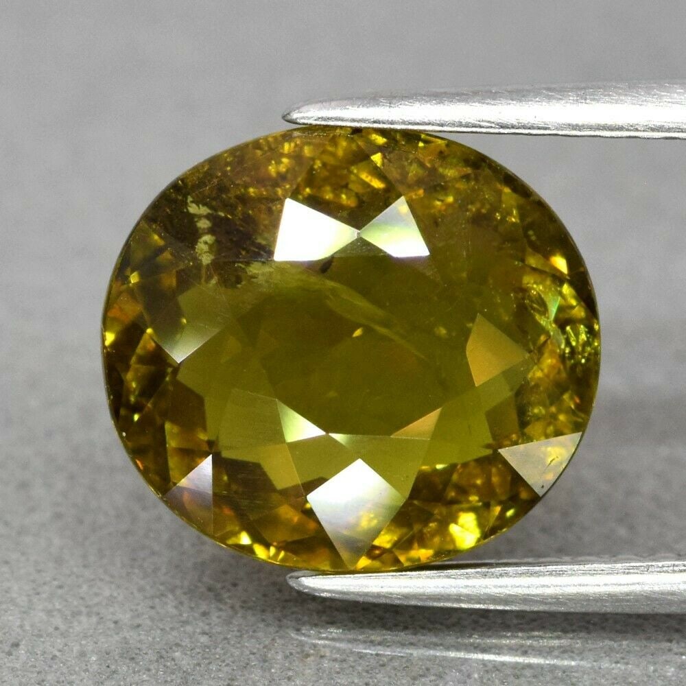 4.23 ct. Natural Greenish Yellow Sphene - MADAGASCAR: 4.23 ct. Natural Greenish Yellow Sphene - MADAGASCAR, AFRICA Color - Greenish Yellow With Rainbow Spark Cut - Oval Clarity - SI1 Ct. wt. - 4.23 ct. Dimensions - 11.00 x 10.00 x 5.40 mm