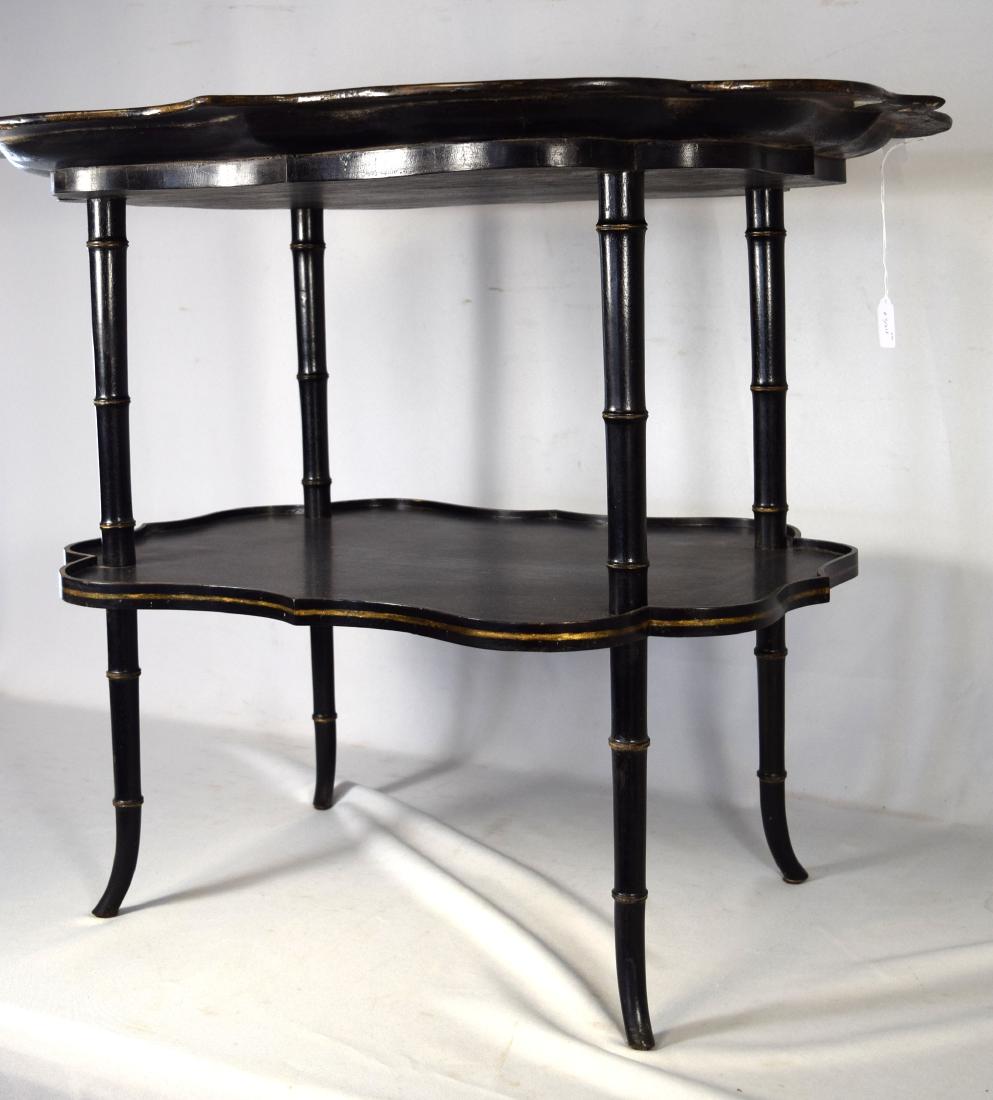 DECORATIVE ENGLISH LACQUERED PAPIER-MACHE TRAY TABLE:: 19th/20th century. Hand painted. Black lacquer top with floral center and gold gilded scroll edge decoration. Tray 32 inches x 25 inches. (Repair tray edge). Bamboo faux legs with bottom shelf