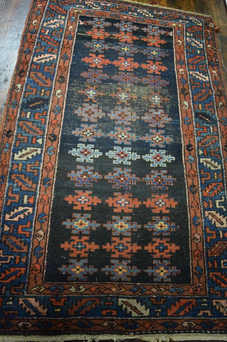 PERSIAN ORIENTAL AREA RUG:: Dark blue ground with repeating geometric pattern. Saw-tooth and wine cup border. Measures 44 inches x 72 inches.