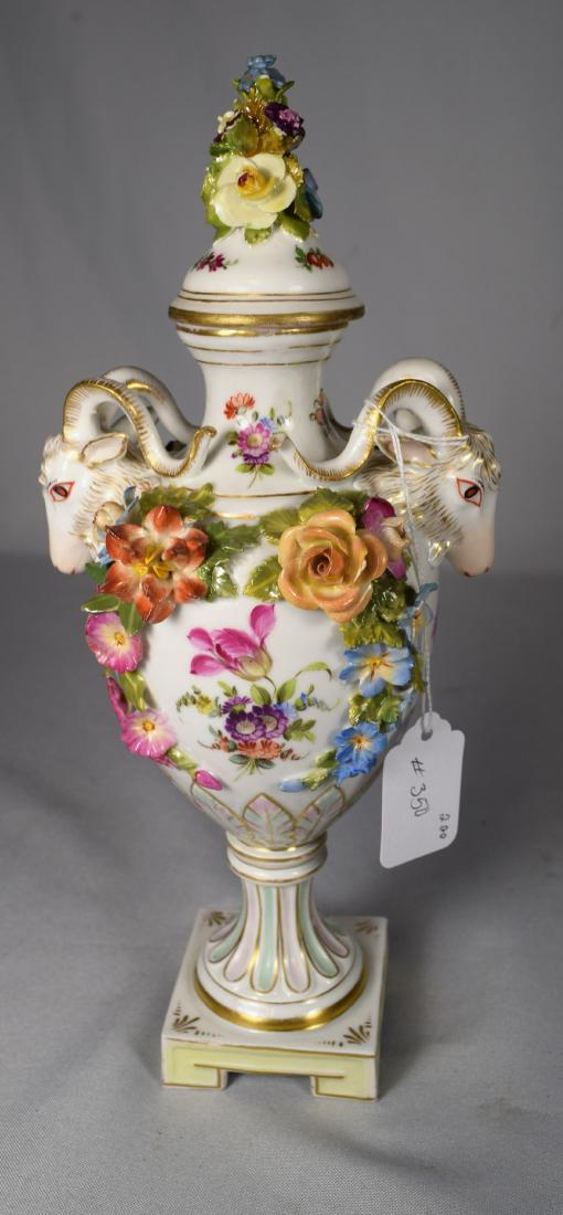 BERLIN KPM TYPE PORCELAIN COVERED URN:: Rams head handles with hand painted classical scene, flowers and accents. Applied flowers. 11 ½ inches tall