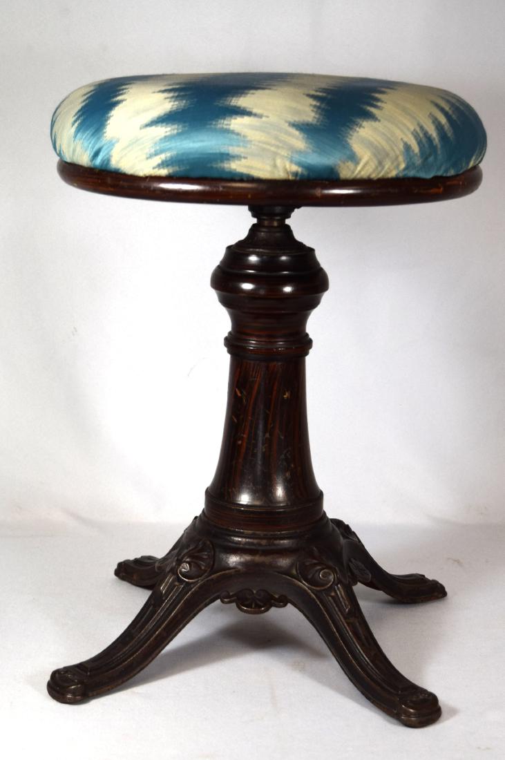 BRIGGS PATENT PIANO STOOL:: Cast iron base with rosewood faux painted. An American piano stool in cast iron with an upholstered seat. The stool has the following information in the iron casting. Piano Stool Patented Oct 23 1866,