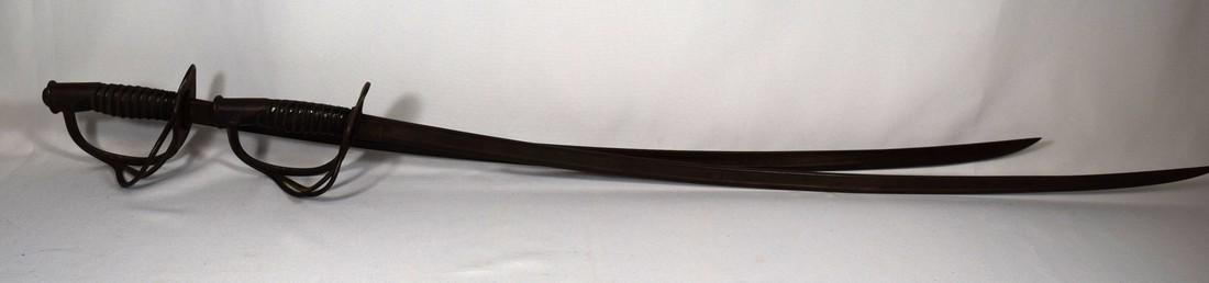 PAIR OF US MODEL 1906 CAVALRY SWORDS:: Leather wire wrapped grips. AmesÂ Sword Manufacturing. Blade marked ASC with bomb icon, 1906. Reverse US JC. Curved blade measures 34 ½ inches long.