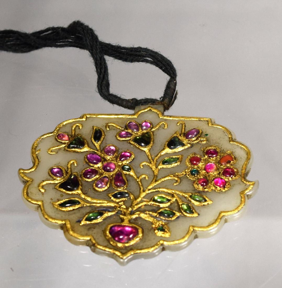 WHITE JADE ISLAMIC/MUGHAL PENDANT:: With semi-precious stones and gold inlay. Floral design. Measures 2 ¼ inches x 1 ¾ inches. Incised decoration back.