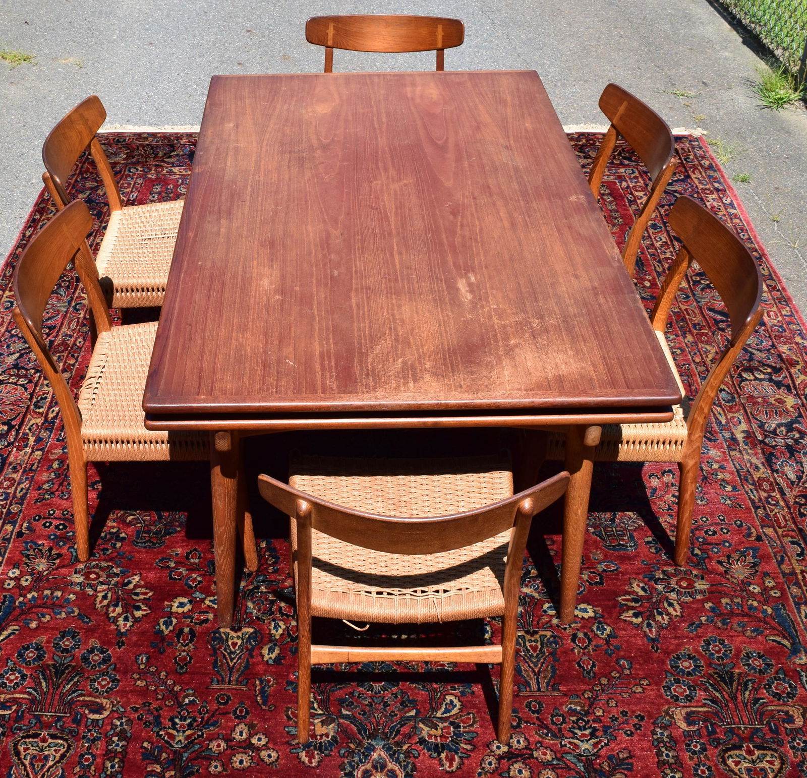 HANS J. WEGNER (1914-2007). TEAK DINING TABLE:: Ca 1950’s/60’s. Two pop-up extending leaves. By Andreas tuck. Signed. Measures 39 1/2 inches wide x 63 inches long closed) x 28 ½ inches tall. Measures 110 inches long fully extended