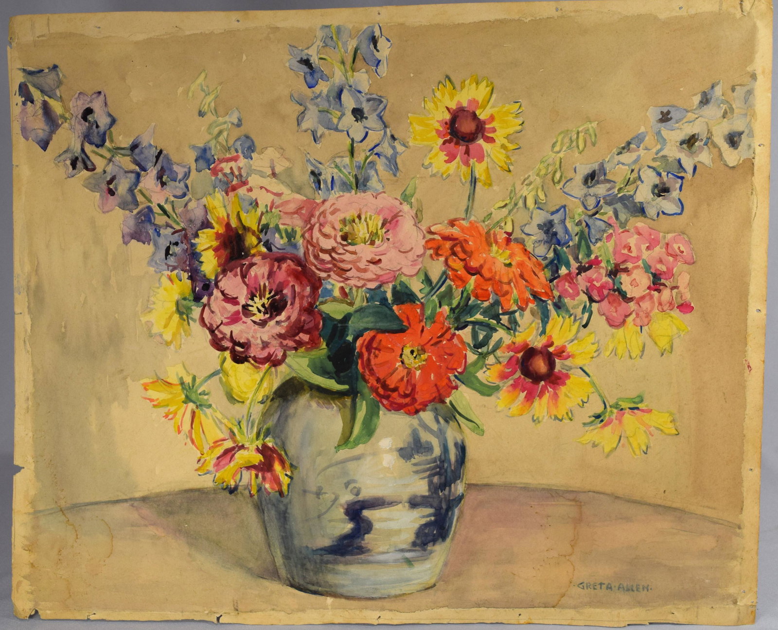 GRETA ALLEN WATERCOLOR PAINTING:: Floral still life, unframed. Red, yellow and orange Zinnias in a Chinese cobalt decorated ginger jar. Measures 16 ¾ inches x 20 ½ inches. Signed lower right.