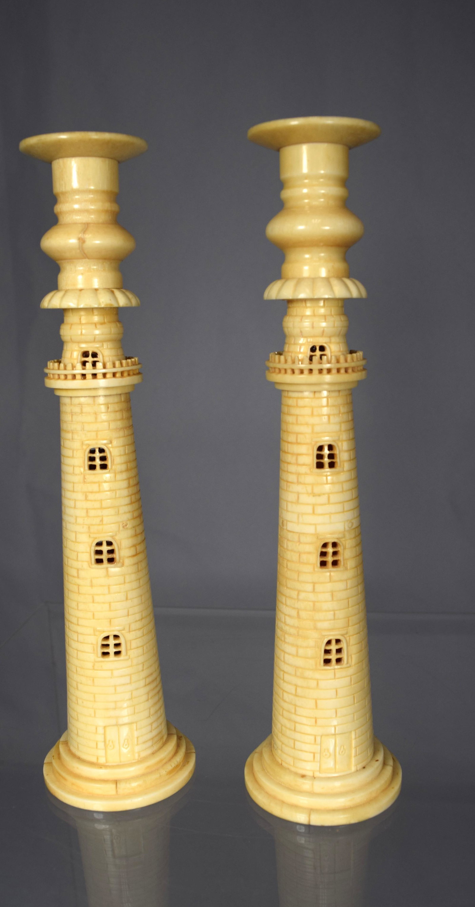 PAIR OF CARVED WHALE BONE CANDLESTICKS IN THE FORM OF: Ca early 20th century, Azores. Measure 8 ¾ inches tall.