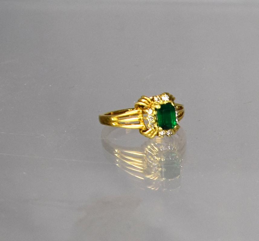 14KT YELLOW GOLD, EMERAL & DIAMOND RING:: Rectangle shape center emerald approximately 1/2 to 5/8. Surrounded by 10 small white round diamonds, approximately 1/32 ct each. Total approximately 3.2 dwt. Ring size 7.5 Good condition. (Inventory 