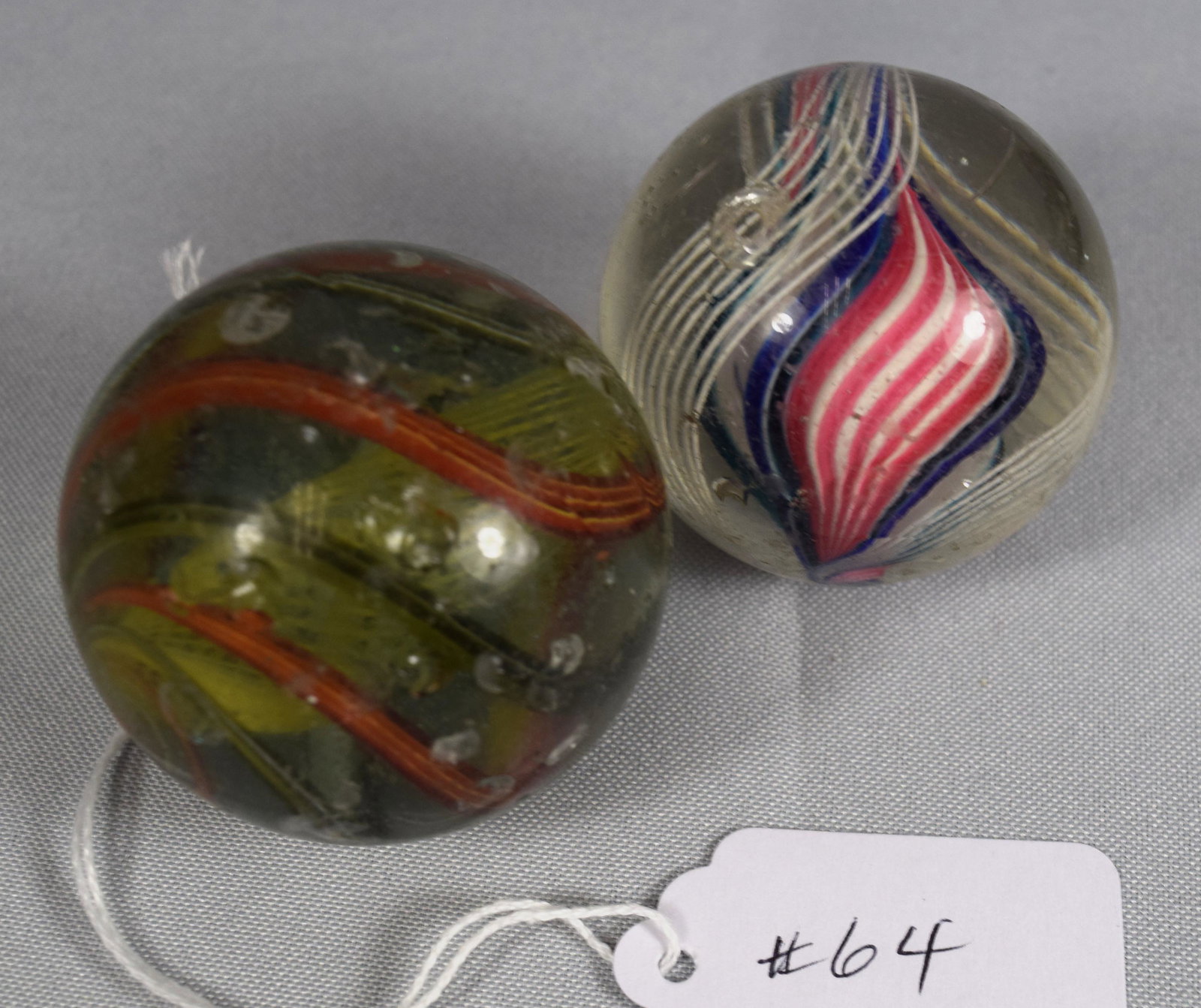 TWO GERMAN 19TH HANDMADE GLASS MARBLES:: Ca 1880-1890. Each approx. 2 & 1 7/8 inches diameter. Swirl marbles.