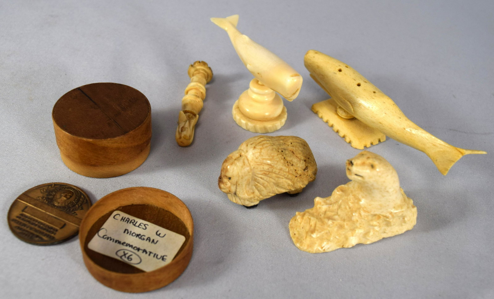 SIX WHALE BONE & MARINE ITEMS:: Consisting of carved Muskox, polar bear, two whales, Stamp or seal and Charles Morgan commemorative metal. Various items. White’s will not ship out of Massachusetts.