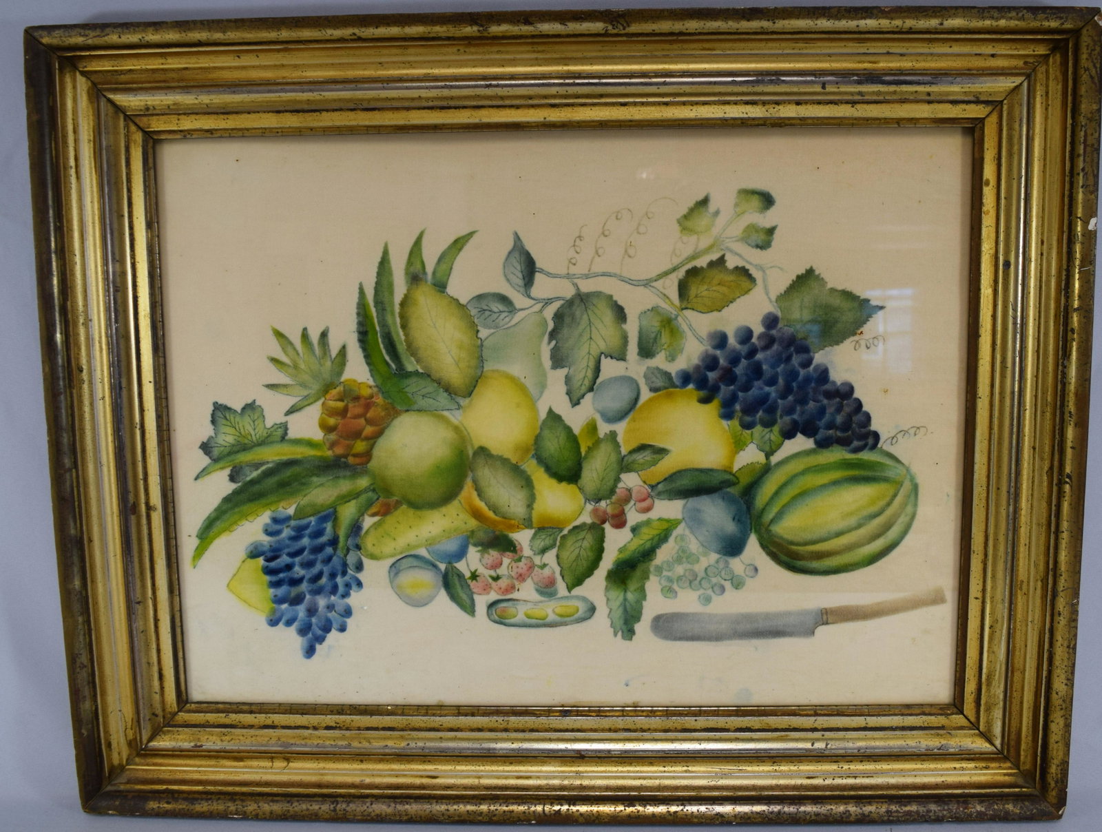 19TH C. FOLK ART THEOREM PAINTING ON VELVET:: Executed by Caroline Wompole (Aunt of Shrieve). Grapes, pineapple, lemons limes and melon and fruit knife. Image 16 ½ inches x 22 ½ inches. Period gilt frame.