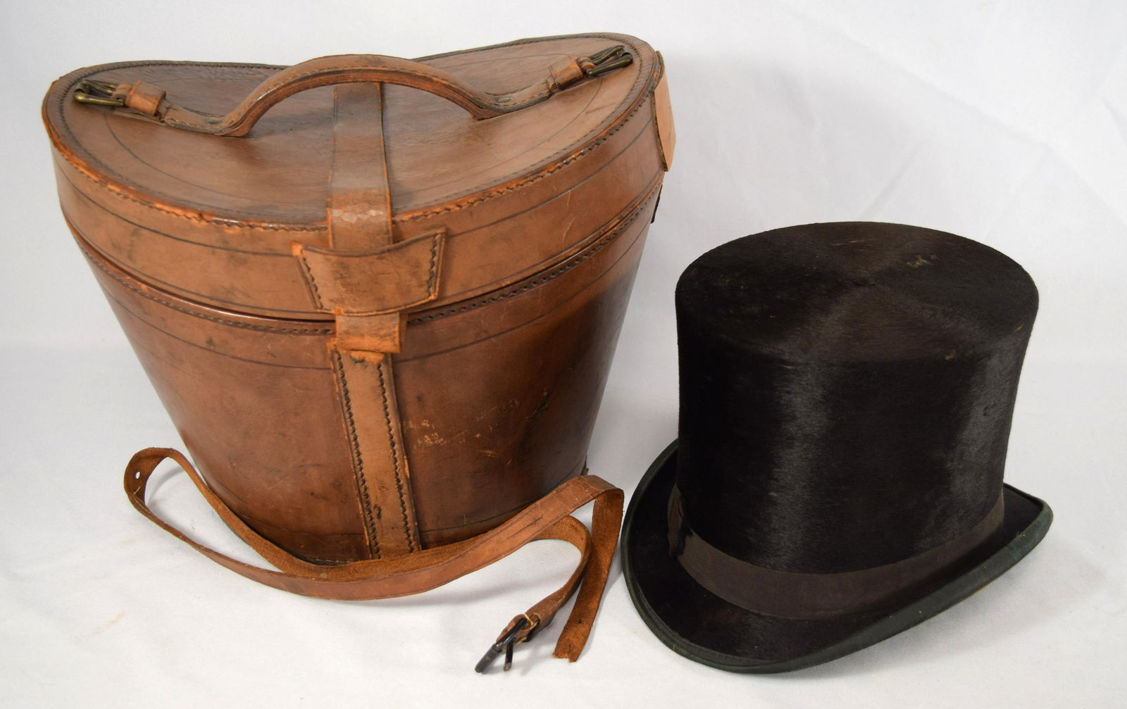 LEATHER HAT BOX WITH TALL HAT:: Ca 19th century. Rhode Island maker.