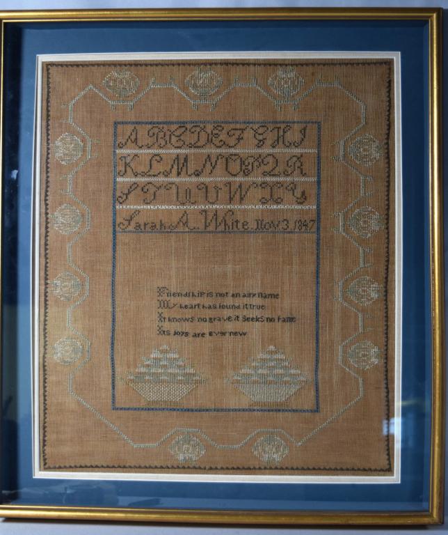 1847 TAUNTON MASSACHUSETTS SAMPLER:: Made by Sarah A. White, daughter of Nancy and Abiathar White of Dighton and Taunton, Massachusetts. A geometric floral border on four sides enclosing an alphabet in capitalletters, four verses on frie