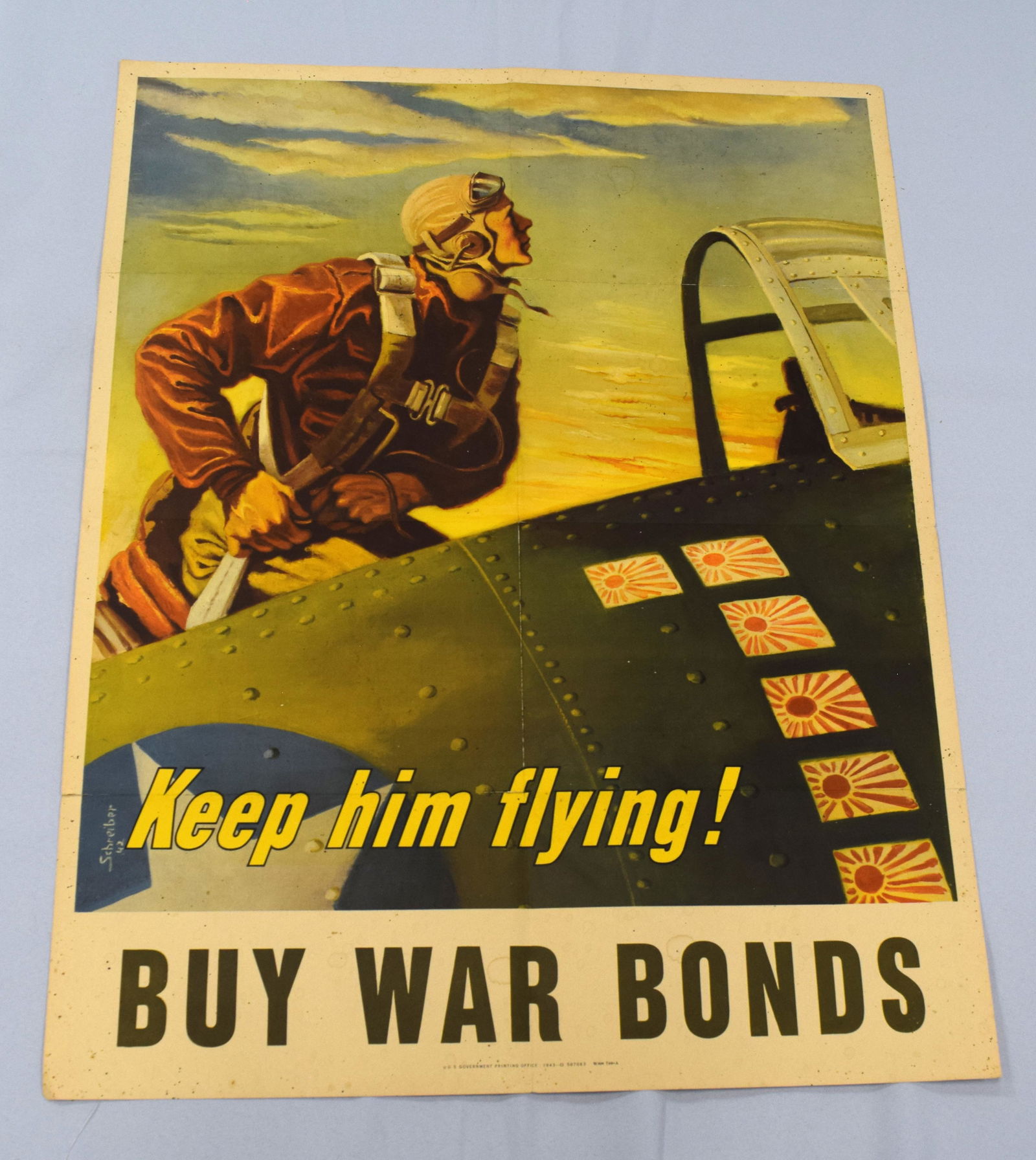 KEEP HIM FLYING WWII WAR BOND POSTER: US Government printing office. 1943-0-507063 WSS 740-A. 22 inches x 28 inches. Fold marks and minor spots. Good condition