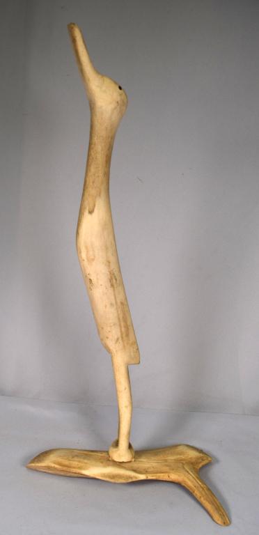 ESKIMO ART BONE & ANTLER CRANE SCULPTURE OR DECOY: Ca. 20th century Eskimo folk art bone & antler Lesser Sandhill Crane sculpture. Measures 22 inches tall x 11 base. Two piece construction. Unsigned. Good condition.