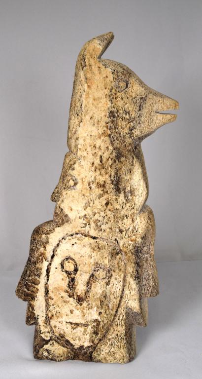 INUIT WHALE BONE FACE & GOAT SCULPTURE: Figural many faces Eskimo inuit whale bone carving sculpure. Measures 17 1/2 inches tall x 9 inches x 2 1/2 inches wide. Unsigned. Good condition.
