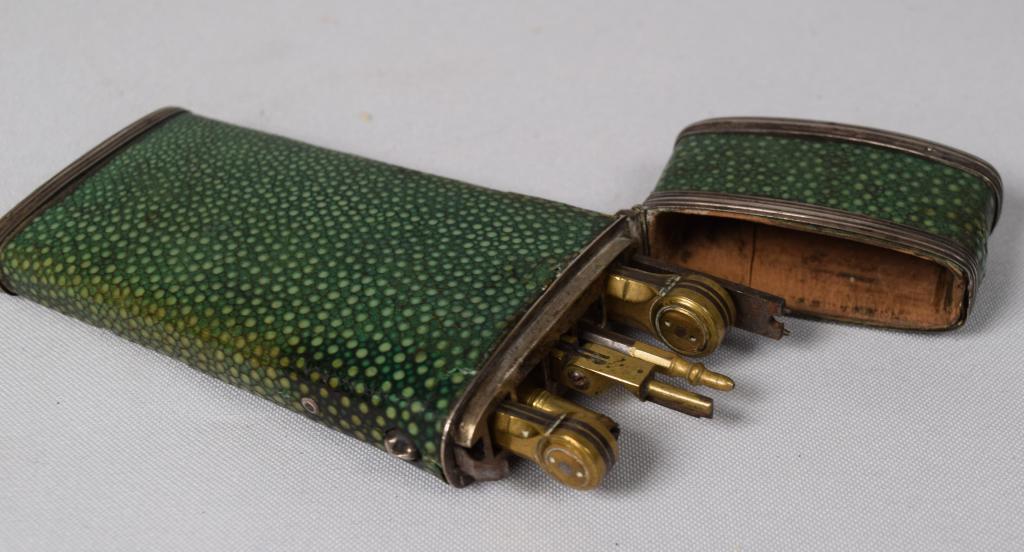 SHAGREEN CASED DRAFTING SET: 18th/19th century. Case containing 6 tools. Green shark skin. Measures 5 inches long. Some loss to shagreen case.