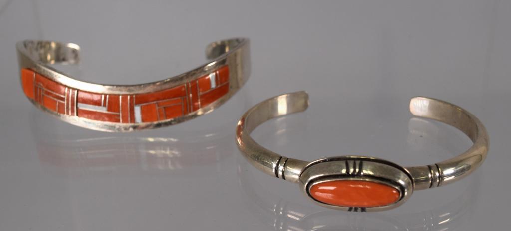 TWO SILVER AND CORAL NATIVE AMERICAN JEWELRY: Consisting of two bracelets. 1) Signed Jackson sterling, coral and MOP cuff bracelets. 2) Sterling and coral cuff bracelet signed Lozgen. Approx. 2.3 troy ounces. Good condition.