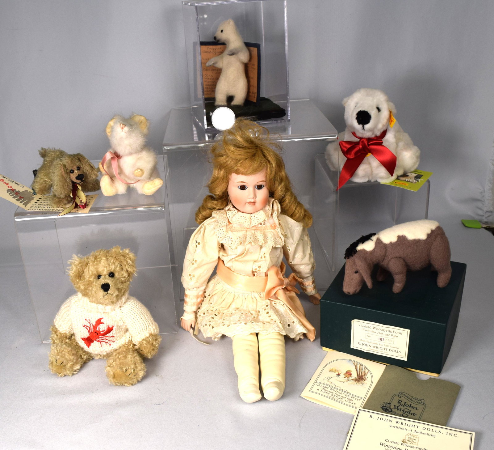 GROUPING OF MISC. STUFF ANIMALS: Consisting of porcelain doll. 2) white mouse. 3) Smoker dog. 4) Lobster teddy bear. 5) Steiff Knut. 6) R. Wright Piglet. (Pooh is missing). 7) Polar bear in case. Various conditions.