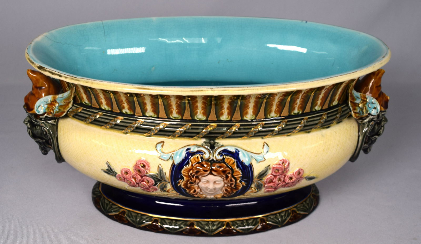 19TH/20TH C RORSTRAND MAJOLICA CENTER BOWL: Majolica Rorstrand oval center bowl with figural handles. 15 inches wide x 7 inches tall. Signed on base. Rim hairlines.