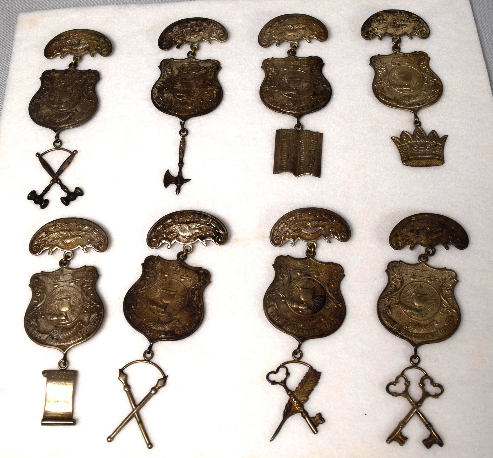 ASSEMBLED SERIES OF GOLDEN GRAIL FRATERNAL METALS: (8) pieces assembled plated metals. 19th century. Metals marked Golden Grail. each approx. 4 1/4 inches long. Good condition.