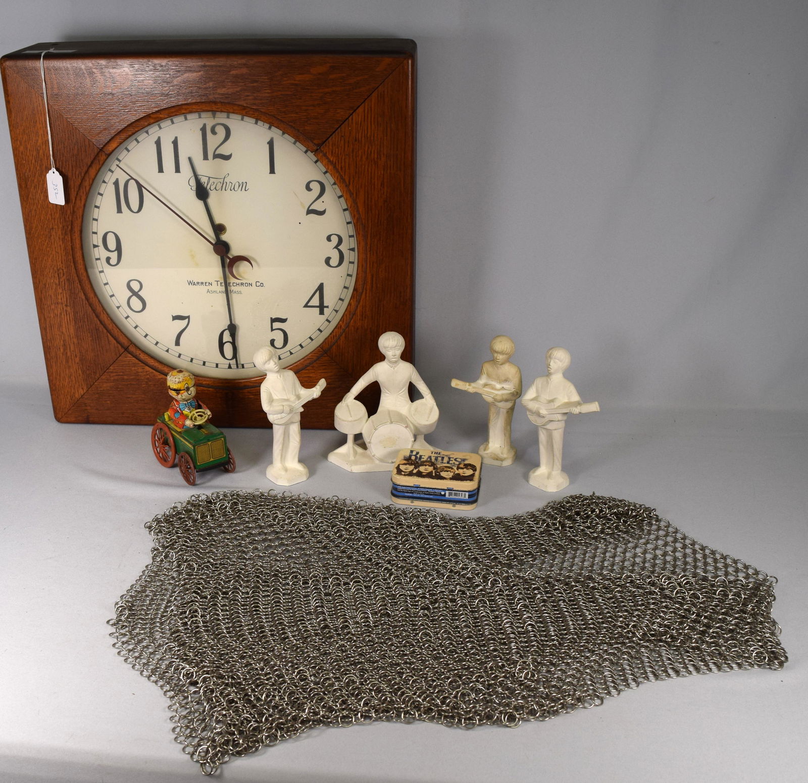 ASSEMBLED MISC GROUPING: Consisting of 1) Telechron oak wall clock. Change to battery works. Working. 2) KNIGHT'S MEDIEVAL CHAINMAIL VEST: 20th century. Good condition. 3) Holland mold four Beatles figures. Good condition. 4)