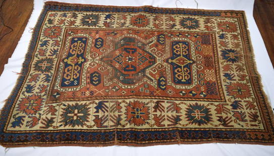 OLD KAZAK ORIENTAL RUG: ca 1870's. Three medallion center with wide crab borders. 71 inches x 47 inches. Good strong colors. Wear and low spots.