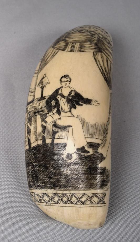 LARGE 19TH C WHALE'S TOOTH SEATED GENTLEMAN:: Large whale's tooth with detailed scrimshaw scene of a seated gentleman with a book. He is in a formal drapered room. Ornate drapery and furnishing details. Registered number. Measures approximately 6