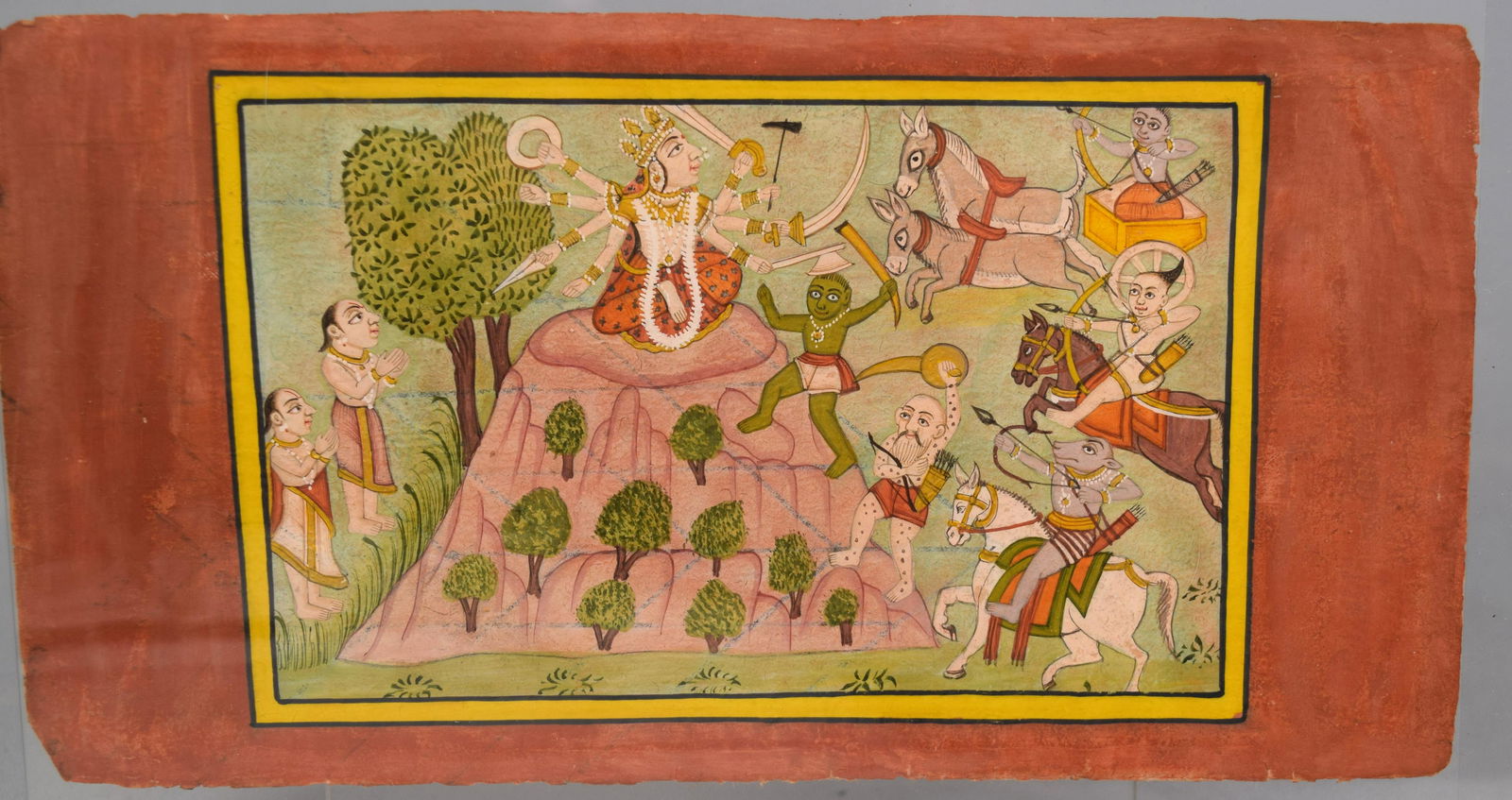 INDIAN PAHARI SCHOOL DEVI SERIES MINIATURE: Miniature painting. Seen is Goddess sitting on the top of a mountain fighting demons to save her devotees standing on the other side of the mountain with folded hands. Pahari paintings weremade in sma