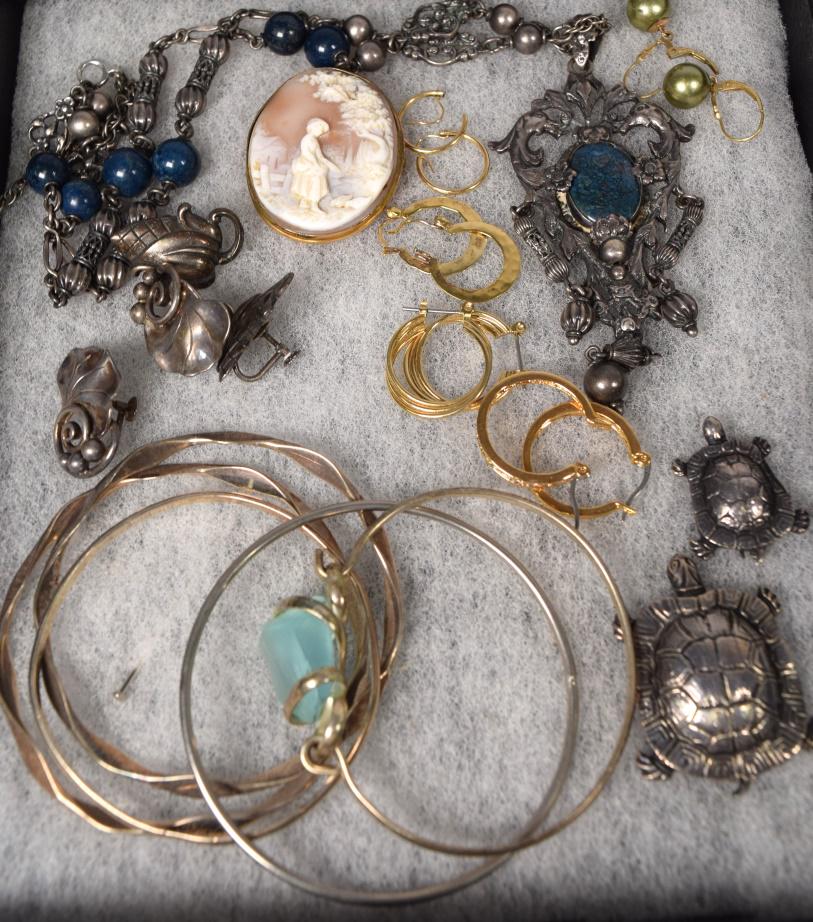 JEWELRY GROUPING: Consisting of shell cameo, Peruzzi sterling necklace, 2 sterling turtle pins, 5 sterling bangle bracelets, 2 sets of sterling earrings, 6 gold plated earrings. Approx. 4.45 troy ouncessterling. Variou