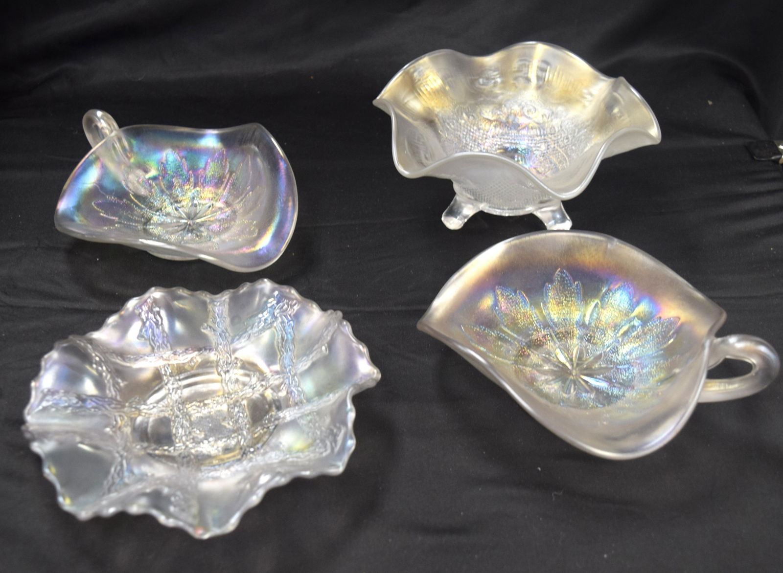 4 CARNIVAL GLASS DISHES IN WHITE: Consists of 1) Two Dugan leaf rays spade nappy both in white, 7 inches. Good condition. 2) Footed candy dish, 7 inches dia. Very very small chip on foot. 3) Dugan & diamond grape vine & lattice 61/2 i