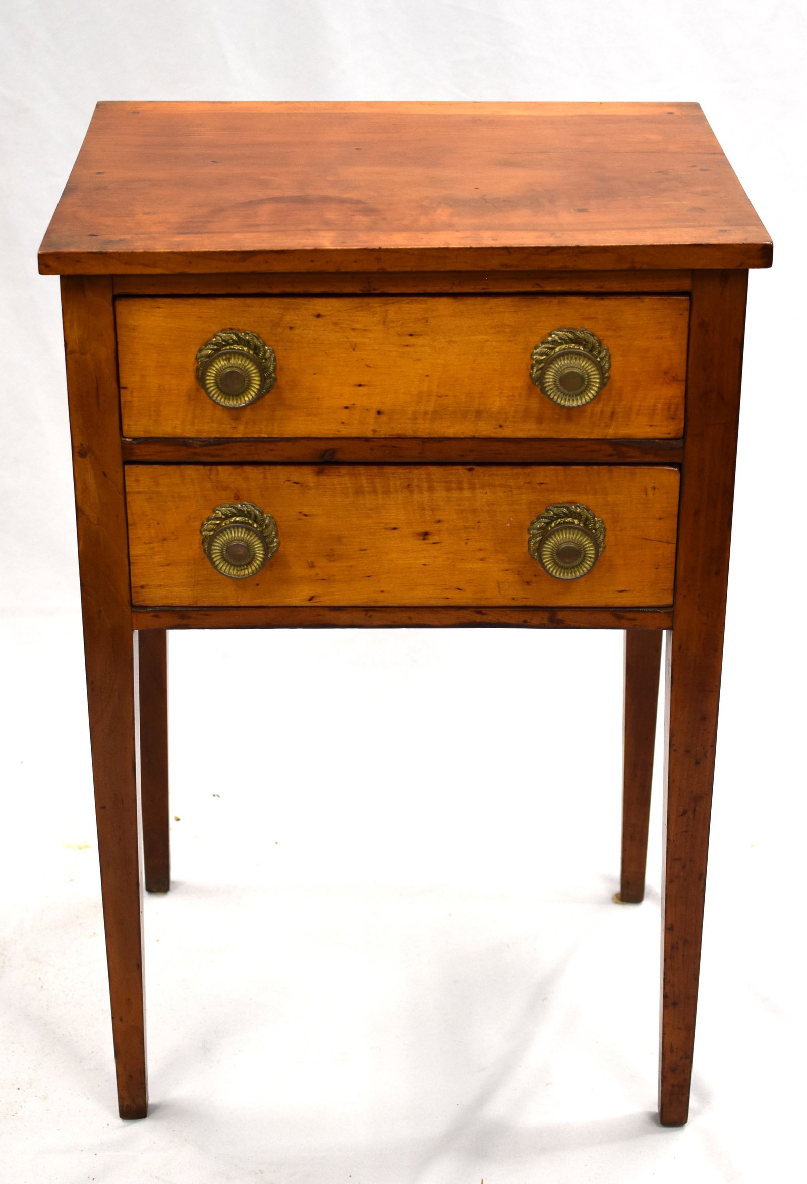 PERIOD HEPPLEWHITE TWO DRAWER STAND: Ca 1810-20. Brass knobs with tiger maple drawer fronts. Straight Tapered legs. maple. Old refinish. 14 1/2 deep x 19 wide x 29 tall. Good condition.