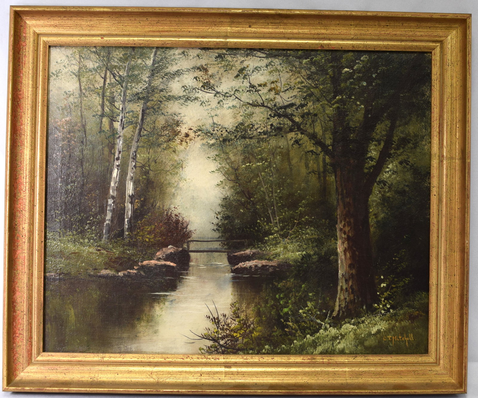 C. T. MITCHELL OIL PAINTING: American School (19th/20th century) Woodland interior with pond, signed C.T. Mitchell, LR. Oil on canvas, image 20 inches x 16 inches. Framed. Old repair. Good condition.