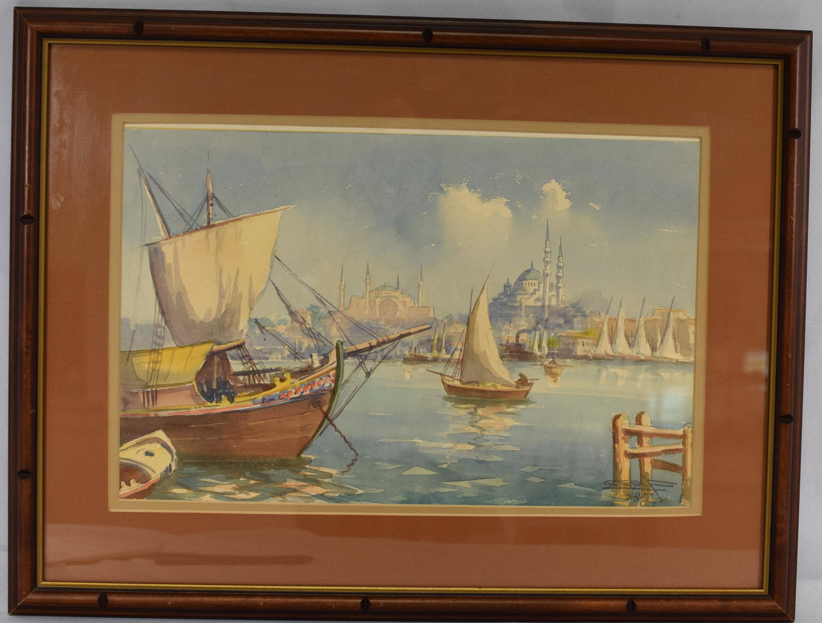 SERIF RENKGORUR 1847-1947 WATERCOLOR PAINTING: Continental School. Ca 1923 or 1928. Watercolor on paper. Framed under glass. Signed lower right. View of Istanbul or Constantinople harbor Turkey with sail boat in harbor. Image 16 inches x 10inches.