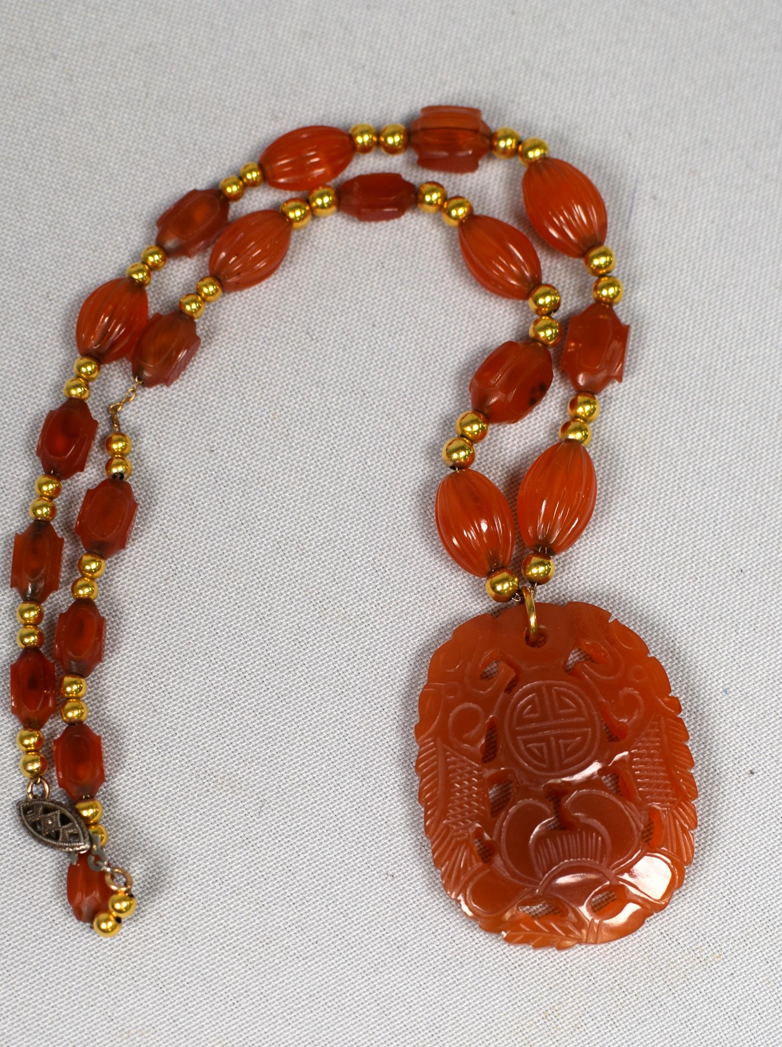 CARVED JADE OR CARNELIAN GOLD BEADED NECKLACE: Carved pendant with carved jade and 14k gold necklace. 14 inch necklace. (Replace clasp). Good condition.