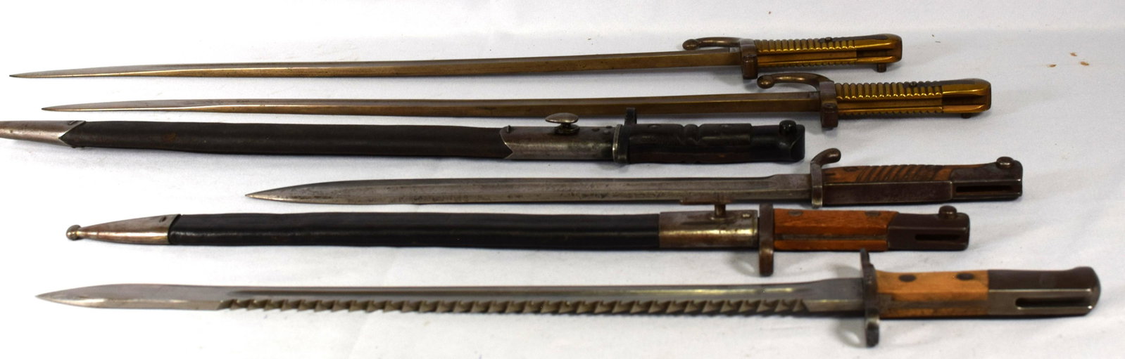 LOT OF 6 BAYONETS: This lot is made up of 6 Bayonets. The group is as follows, 1) M1914 Sawback Pioneer "H.S. 62455", 24" very good condition. (2) 1 model 1868 French bayonet, marked "H.D. 1868" very clean condition. (3