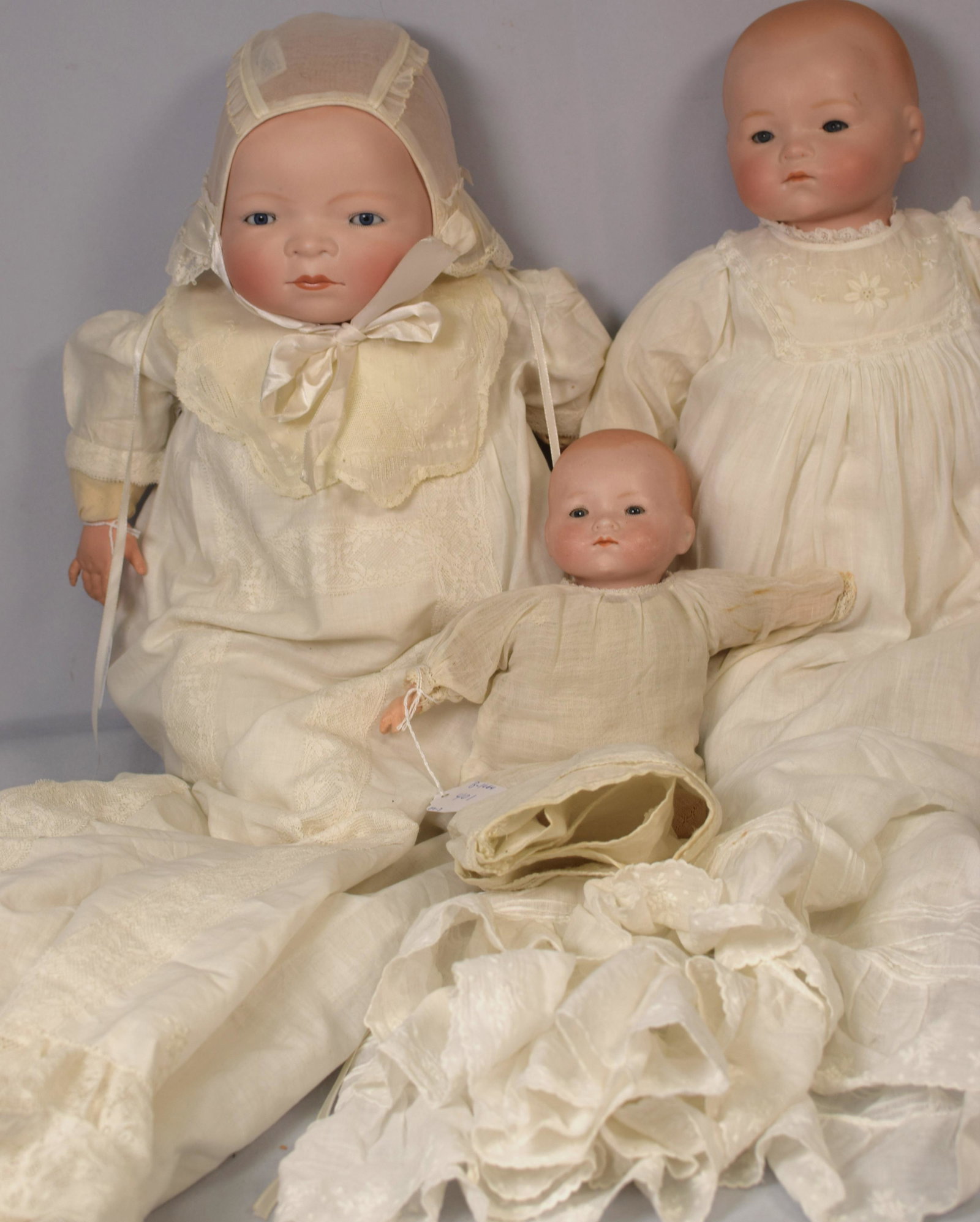 (on-3) ANTIQUE BISQUE PORCELAIN BYE-LO BABY DOLLS: Ca early 20th German century 1920's Bye-Lo-Baby dolls. Consists on 1) Grace Putnam bisque porcelain baby doll. Signed in back of head. 18 inches tall. Blue paperweight eyes. Hand madeclothing. Plastic
