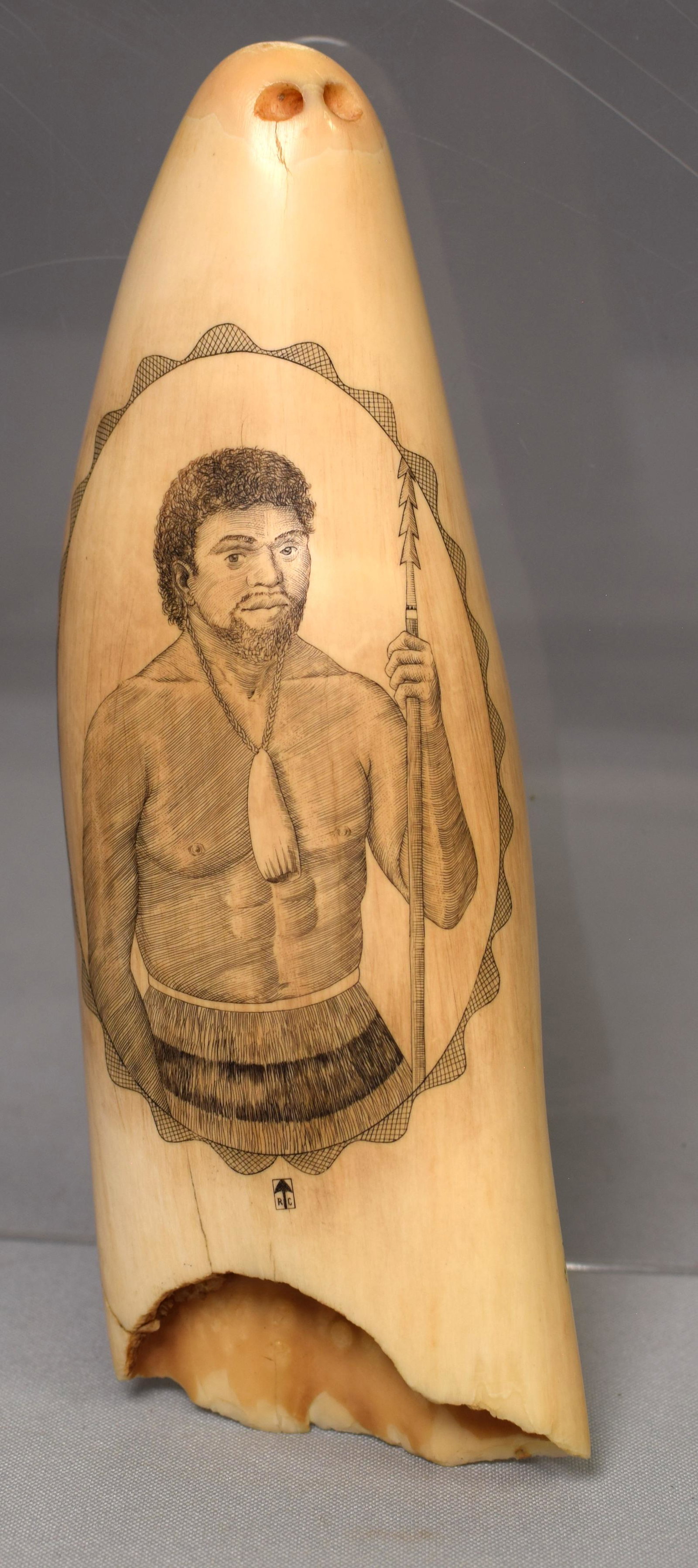 EARLY LARGE SCRIMSHAW WHALE TOOTH MAORI NATIVE: Large early whale tooth with detailed half figure portrait of believed to be a Maori native with a spear and tooth pendant. The Maori are the indigenous Polynesian people of mainland NewZealand. Tooth