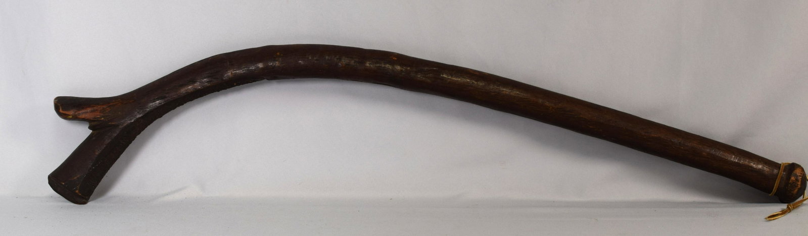 FIJIAN DANCE AND CEREMONIAL CLUB: Fijian native dance and ceremonial club made in the form of a gunstock and carved from wood with a nice patina. Measures 38 inches. Good condition with expected wear.