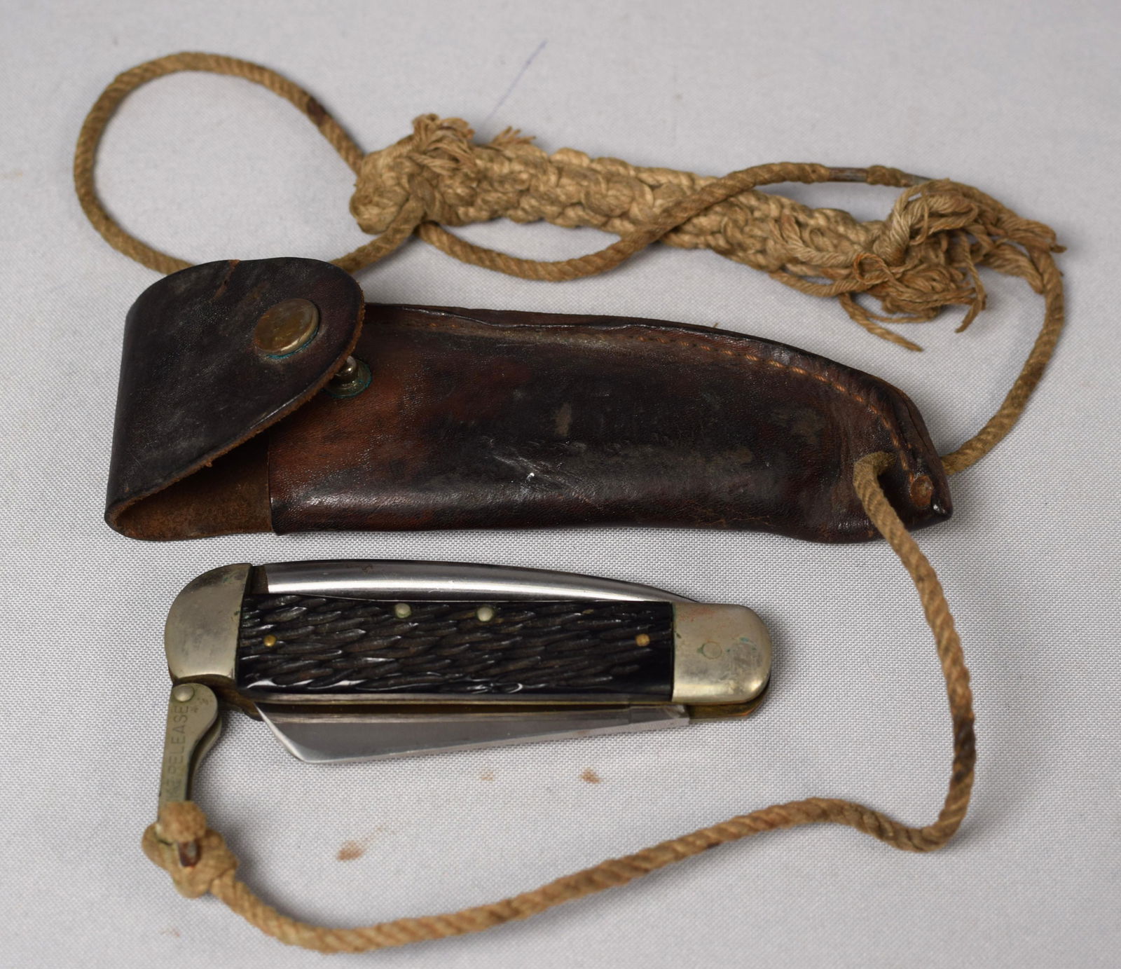 SCHRADE #735 SAILORS FOLDING KNIFE WITH FID: Old sailor made lanyard with fancy knotting and sailor made leather sheath. 6 inches long. Good condition.