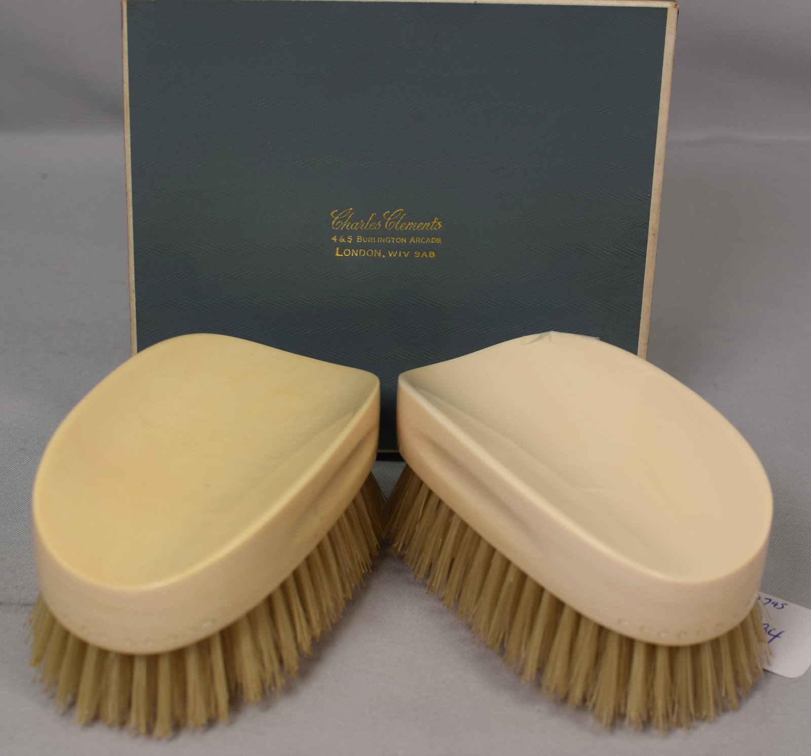 CHARLES CLEMENTS BONE SHOE BRUSH SET: Set of two antique bone shoe brushes from Charles Clements,London in original box. Each measures 5 inches x 2.5 inches .Beautiful condition,minimal wear.
