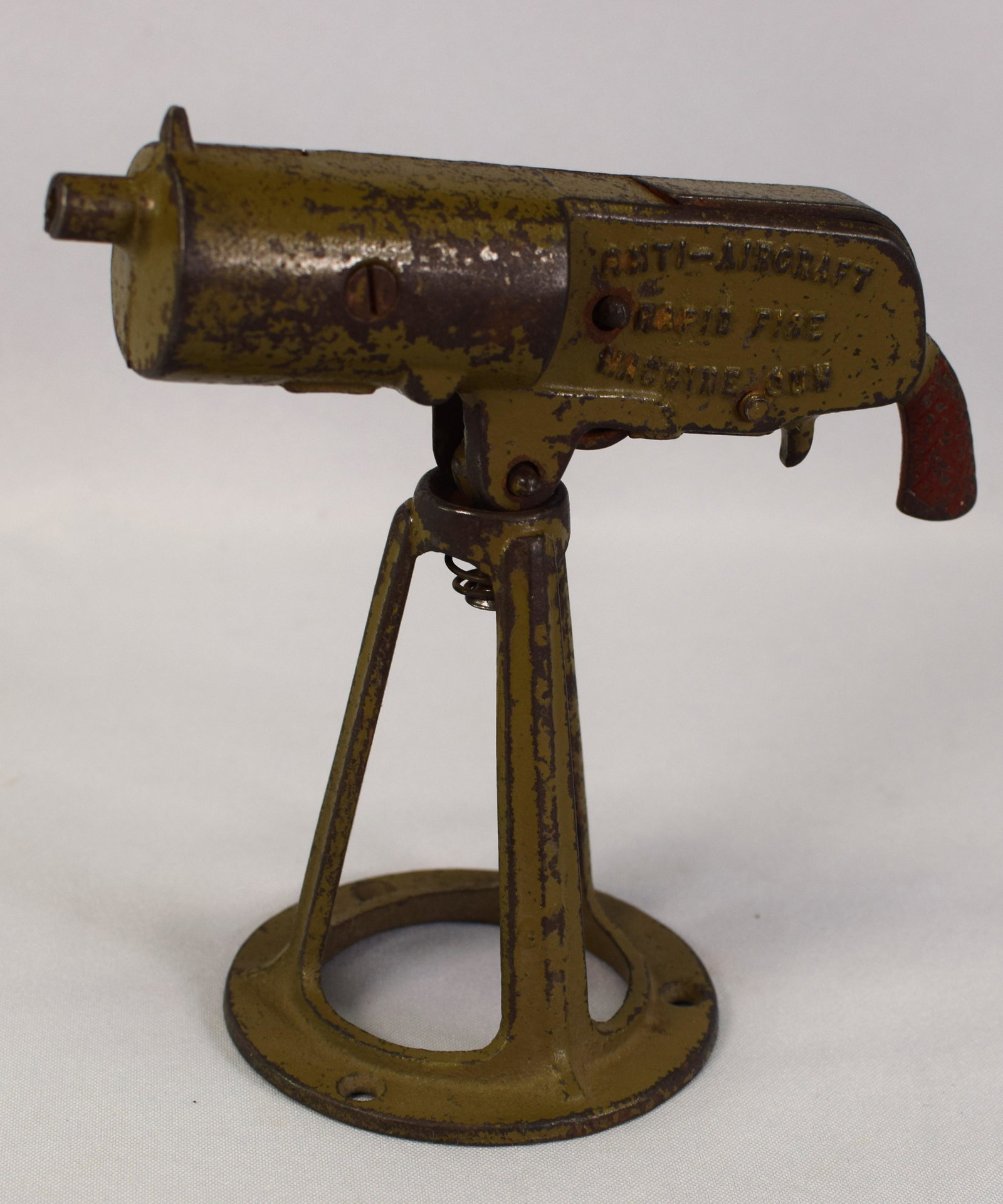 ANTI AIRCRAFT RAPID FITE TOY MACHINE GUN: Ca 1920. Cast iron grey iron anti-aircraft rapid fire machine cap gun. 7 inches long x 6 inches tall. Working condition. Original paint. Some wear.