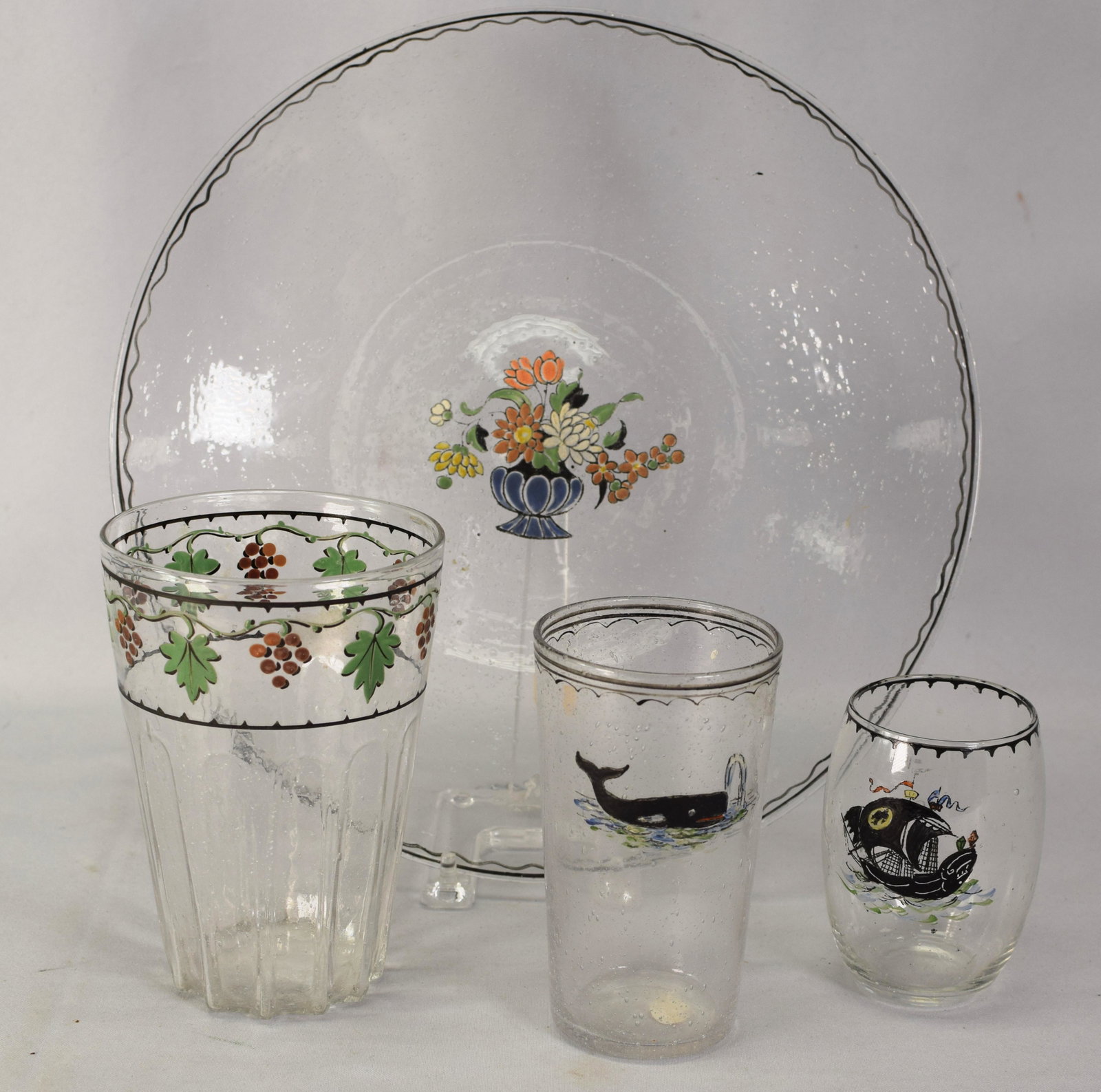 PAIRPOINT TAVERN GLASS GROUPING: Grouping of 4 Pairpoint Tavern Glass pieces. 1). Clear tumbler decorated with a spouting whale. Measures 5.5 inches tall. Good condition. 2). Clear drinking glass decorated with pirate ship.Measures 4