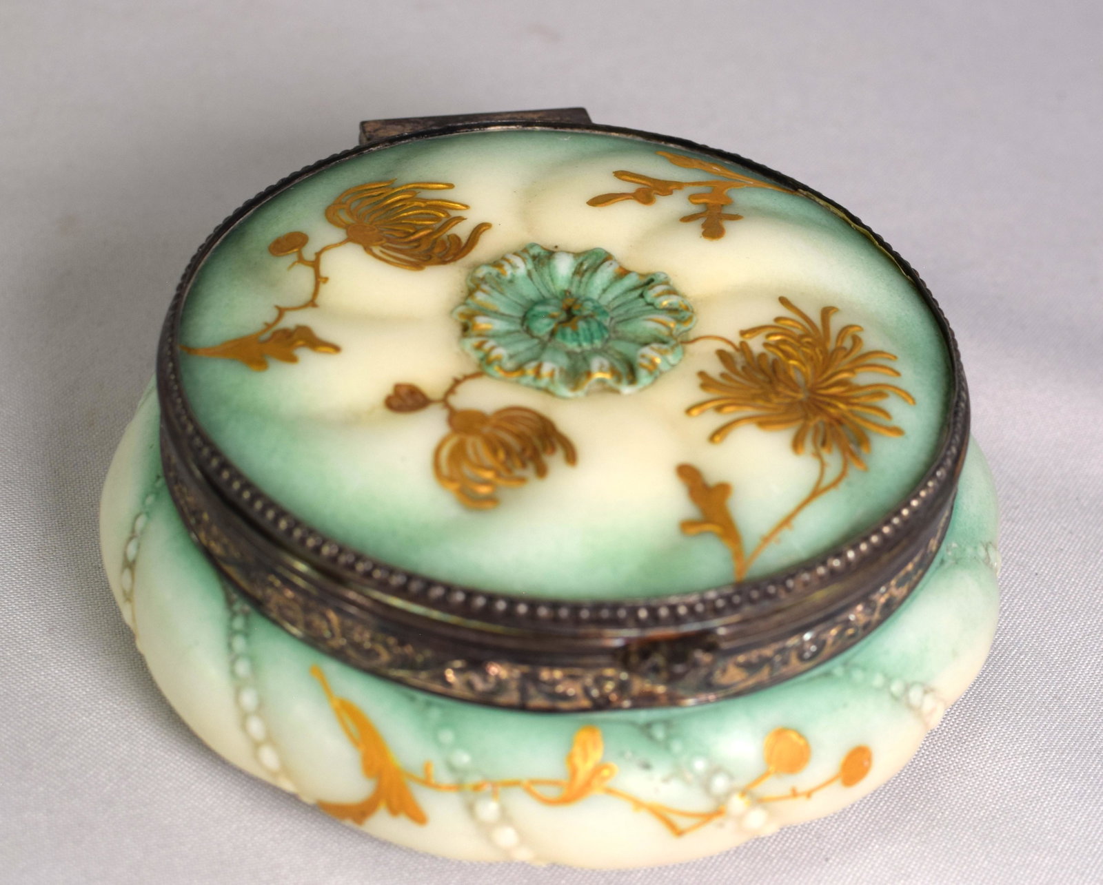 PAIRPOINT JEWELRY CASKET DRESSER BOX: 19th century Pairpoint jewelry casket dresser box in milk glass with floral gilt decoration and metal trim, marked PMC 4611 on bottom. Good condition.