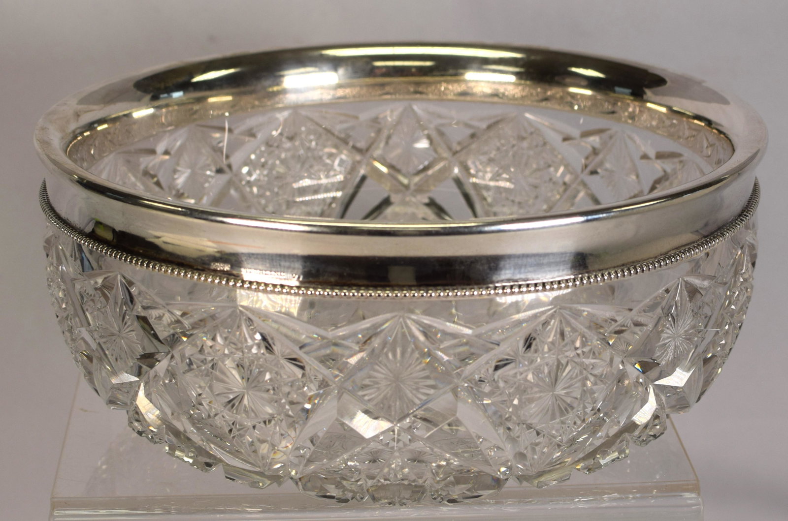 AMERICAN BRILLIANT CUT BOWL WITH READ & BARTON SILVER RIM: Beautiful brilliant cut center bowl (9 1/4 in.) with a solid silver rim. Rim is market sterling with Read & Barton hallmarks. Very nice condition.