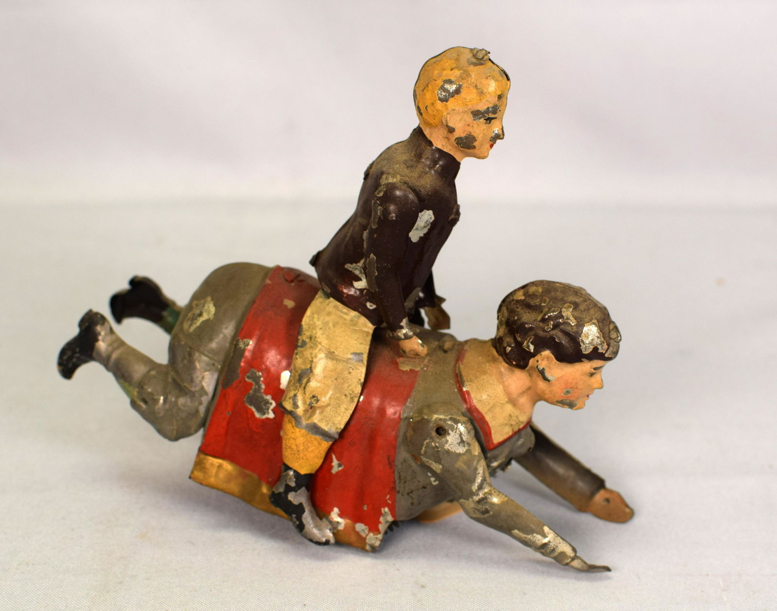 RARE GUNTHERMANN WIND UP TIN TOY, ORIG.: Very unusual and rare early Gunthermann wInd up toy. Depicts a man riding on the back of a woman. Has much of its original paint and is working. Measures 6 1/2 x 6 in. Don't miss out on this one.