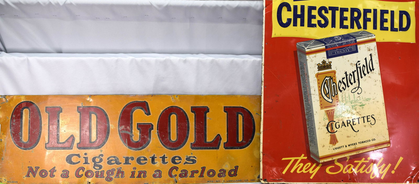 2 OLD GOLD CHESTERFIELD PORCELAIN TIN SIGNS: This is for 2 vintage cigarette advertising signs. The 1st is a heavy enamel sign for Old Gold cigarettes. It measures 12 x 36 in. and is in solid condition with signs of wear and fading.The 2nd is a