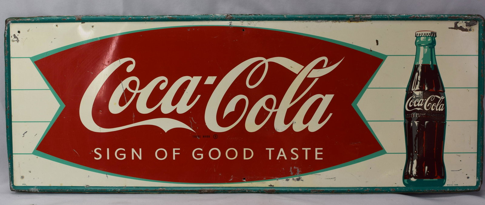 1963 COCA TIN SIGN FISTAIL LOGO W. BOTTLE: Beautiful 1963 Coca-Cola tin sign in very good condition. Measures 12 x 32 in. Some scratching and signs of wear but mild considering the age. Excellent colors.