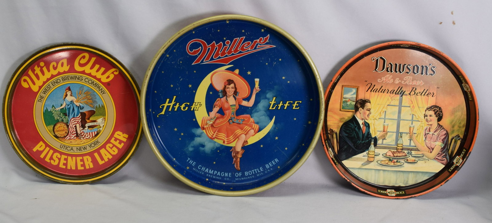 LOT 3 VINTAGE BEER TRAYS MILLER UTICA CLUB DAWSONS: This is nice lot of clean, vintage beer trays. There is a Miller High Life, 13 1/2 in., a Utica Club tray, 11 in, and a Dawson's Ale, 12 in.. All in excellent condition.