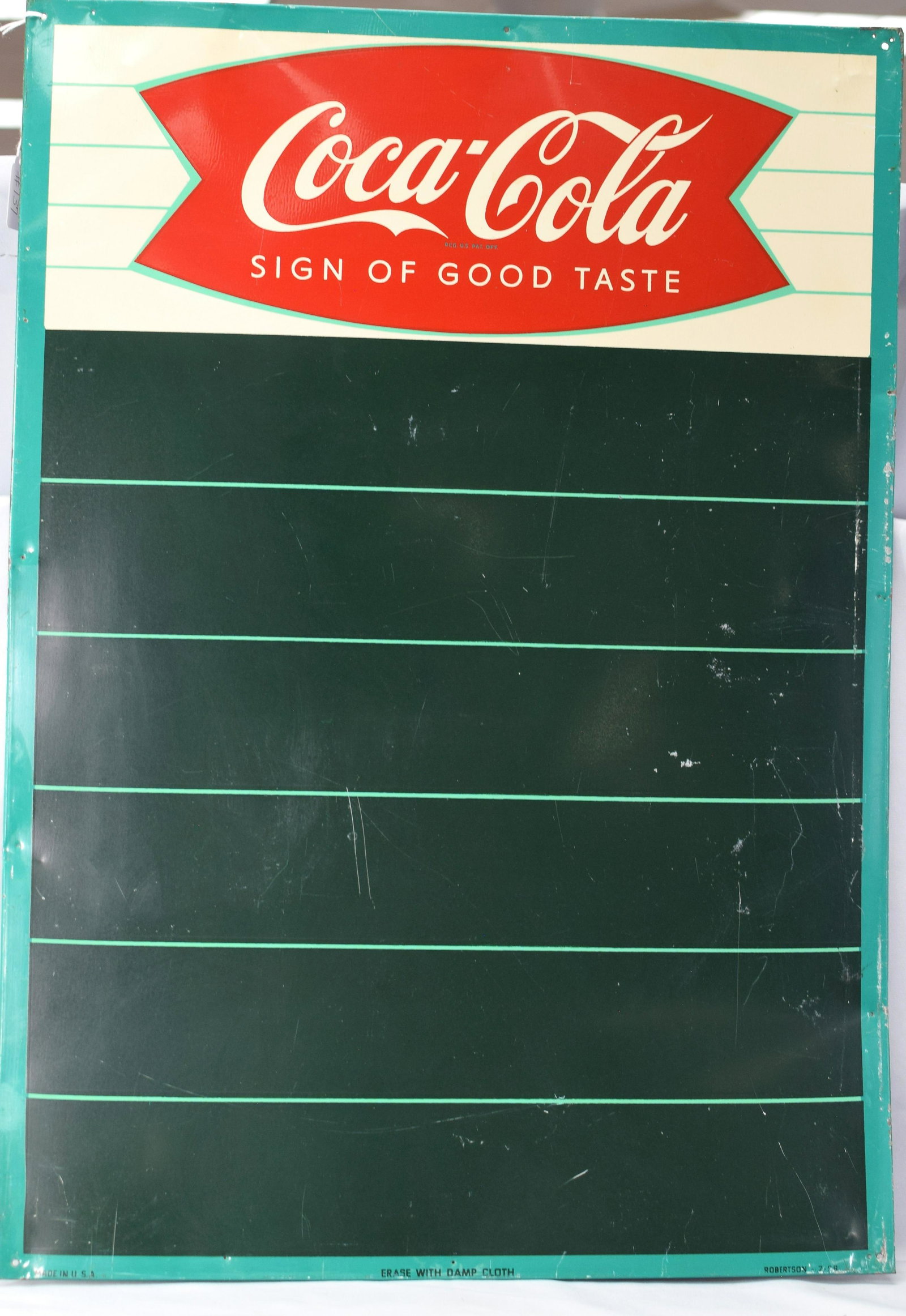1958 COCA-COLA FISHTAIL MENU TIN SIGN: Wonderful 1958 Coca-Cola fishtail menu sign in excellent condition. Has 8 nail holes from hanging and very minor surface scratching. Colors are bright and glossy. Great example. 19 1/2 x27 1/2 in.